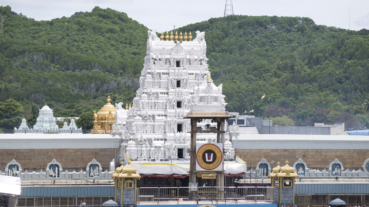 The silver-clad gopuram of the Venkateswara temple at Tirumala against the green Seshachalam hills