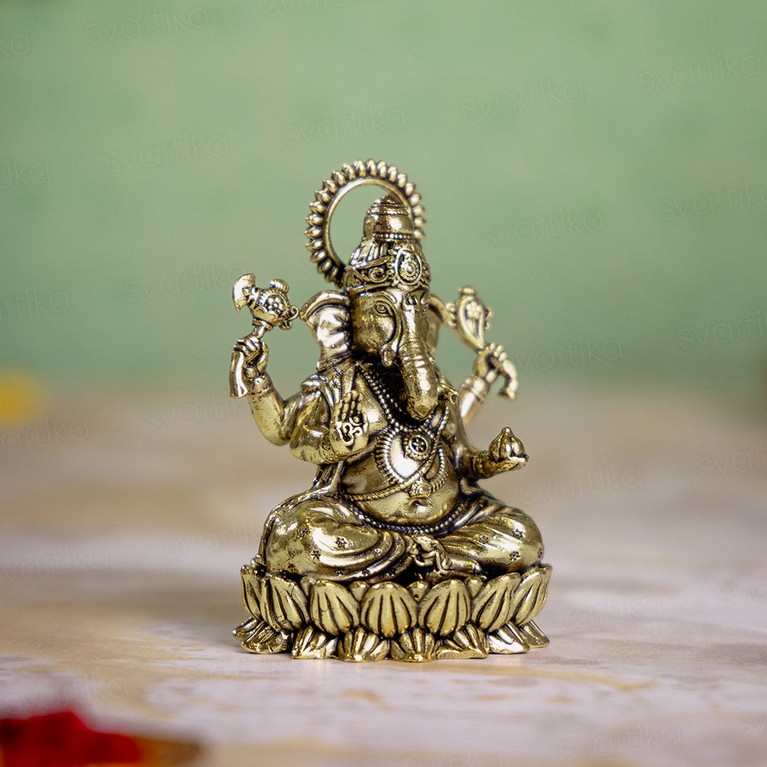 brass ganesh murti sittiing on lotus 