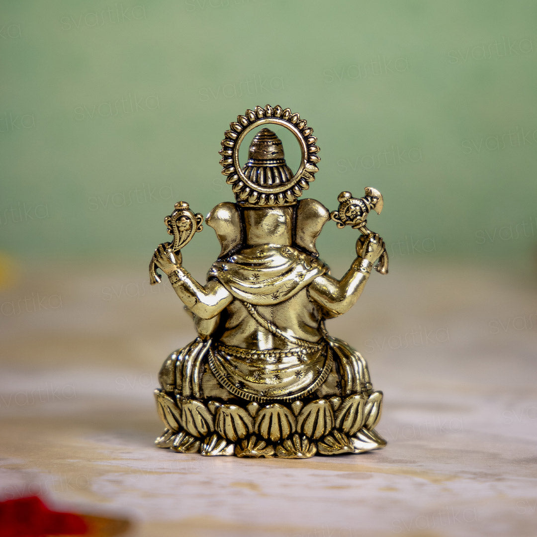 brass ganesh statue sittiing on lotus 