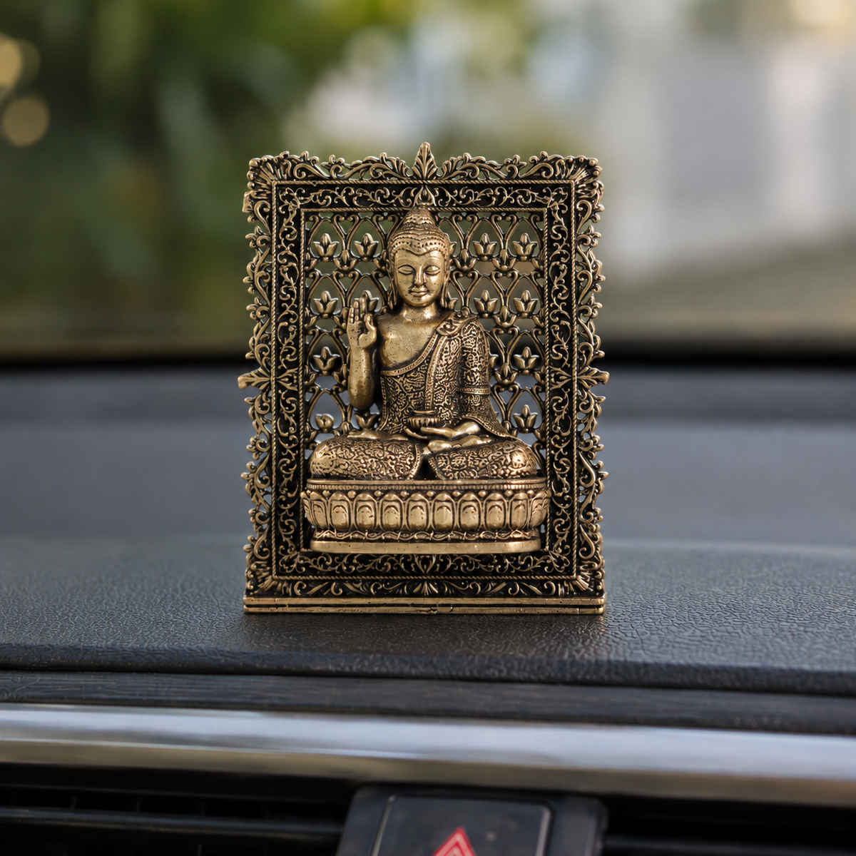 Brass framed Buddha idol for car dashboard, close view