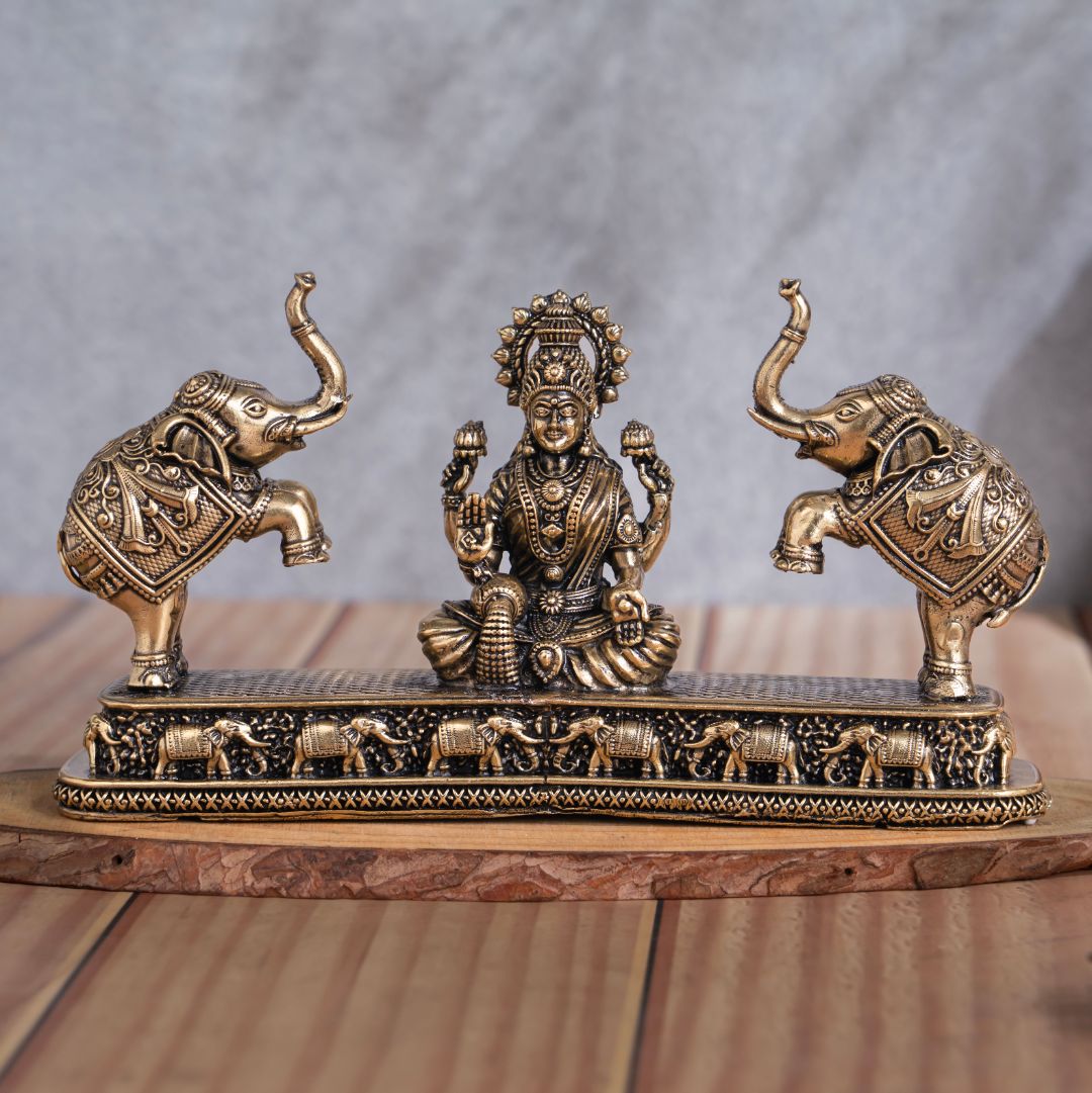 Brass Gaja Lakshmi murti seated on a lotus with an elephant pair on either side
