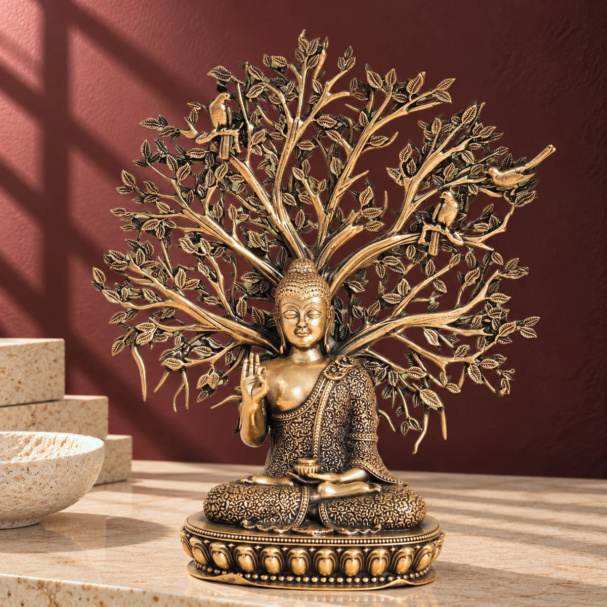 Brass Gautam Buddha murti seated under the Bodhi tree, with birds perched in the leafy canopy