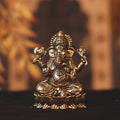 brass sitting ganesh statue on lotus