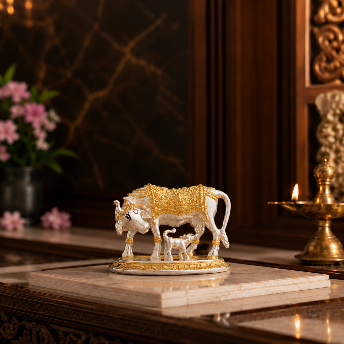Svastika Kamdhenu cow with calf gold and silver plated idol in a premium home temple setting