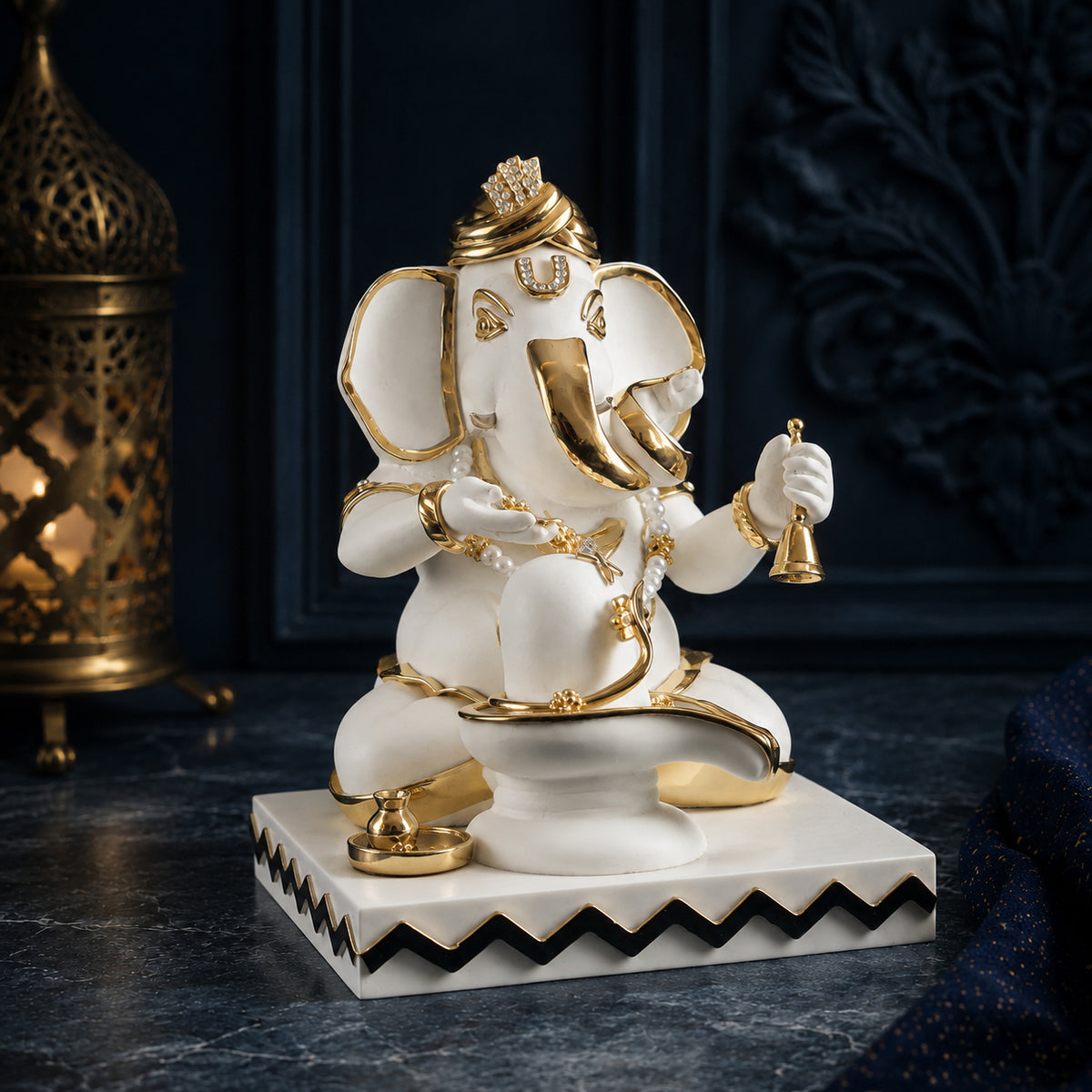Pooja Ganesha idol in white and gold, three-quarter view