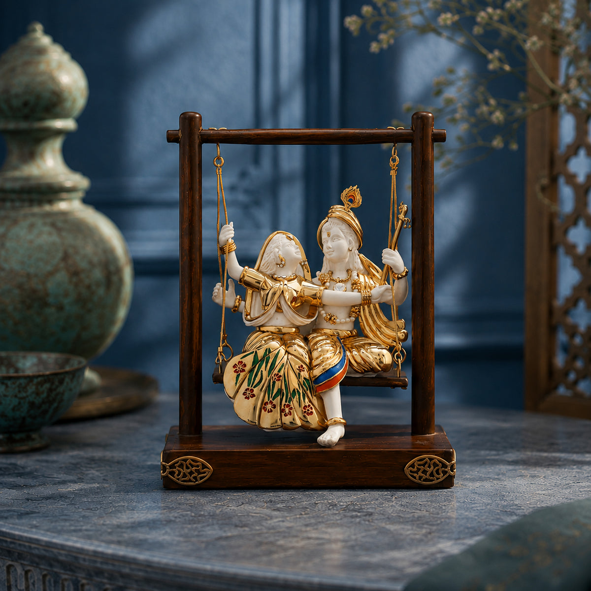 Radha Krishna swing murti in white and gold, close-up view