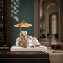 Svastika resting Ganesh idol with umbrella for car dashboard, white and gold 4 inch front hero view